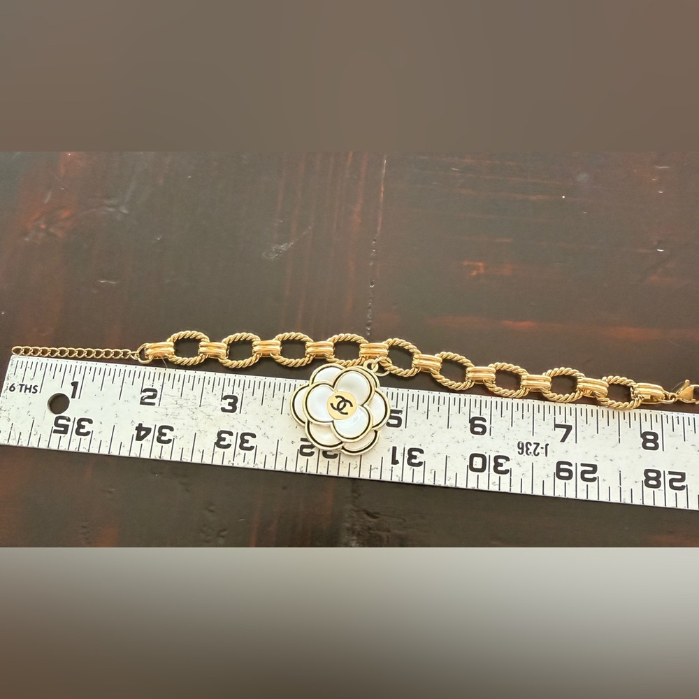 Chanel EUC Gold Tone bracelet
Camellia Enamel 3D charm on 7” 
Stainless Figaro - Picture 8 of 9